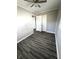 Comfortable bedroom featuring modern vinyl floors and ample closet space with natural light from two windows at 728 Lonsvale Dr, Anderson, IN 46013