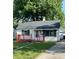 Charming single-story home featuring a red porch, well-maintained lawn, and a detached garage at 728 Lonsvale Dr, Anderson, IN 46013