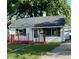Charming single-story home featuring a red porch, well-maintained lawn, and a detached garage at 728 Lonsvale Dr, Anderson, IN 46013