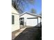 A two-car garage is displayed with a white exterior, accessible through a secure gated area at 728 Lonsvale Dr, Anderson, IN 46013