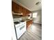 Functional kitchen featuring white appliances, laminate countertops, and abundant natural light at 728 Lonsvale Dr, Anderson, IN 46013
