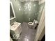 Compact bathroom featuring modern toilet, sink, and partially finished walls at 7835 Caswell St, Indianapolis, IN 46259