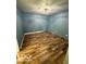 Well-lit bedroom featuring neutral-colored walls, hardwood flooring, and a modern ceiling light at 7835 Caswell St, Indianapolis, IN 46259