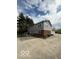 Two-story home with gray siding and a three car garage at 7835 Caswell St, Indianapolis, IN 46259
