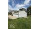 Three car garage adjacent to the home with a well maintained lawn at 7835 Caswell St, Indianapolis, IN 46259