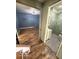 Hallway featuring hardwood floors with view to a bathroom and another room ahead at 7835 Caswell St, Indianapolis, IN 46259