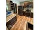 Modern kitchen with stainless steel appliances, dark wood cabinets and island sink at 7835 Caswell St, Indianapolis, IN 46259
