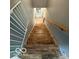 Staircase with wood stairs and gray walls leading to lower level at 7835 Caswell St, Indianapolis, IN 46259