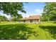 Expansive backyard featuring mature trees, manicured lawn, stone and siding home exterior with gazebo at 8111 Timberwood Dr, Plainfield, IN 46168