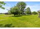 Spacious backyard featuring large trees, lush green lawn and a shed, offering ample space for outdoor enjoyment at 8111 Timberwood Dr, Plainfield, IN 46168