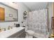 Neutral bathroom with a gray vanity, framed mirror, and a shower with decorative curtain at 8111 Timberwood Dr, Plainfield, IN 46168
