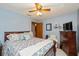 Comfortable bedroom showcasing a large bed with patterned linens, a ceiling fan, and coordinating decor at 8111 Timberwood Dr, Plainfield, IN 46168