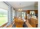 Bright dining area featuring a wooden table, chairs, and a sunlit window at 8111 Timberwood Dr, Plainfield, IN 46168