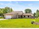 Charming stone home with a well-maintained lawn and inviting curb appeal at 8111 Timberwood Dr, Plainfield, IN 46168