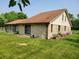 Back of home with stone facade and a well-manicured lawn at 8111 Timberwood Dr, Plainfield, IN 46168