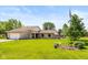 Charming stone home featuring a well-manicured lawn and a decorative American flag at 8111 Timberwood Dr, Plainfield, IN 46168