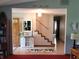 Open-concept foyer featuring a staircase, white cabinet and tiled floor at 8111 Timberwood Dr, Plainfield, IN 46168