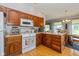 Efficient kitchen featuring wooden cabinets and a view into the dining area at 8111 Timberwood Dr, Plainfield, IN 46168