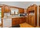 Functional kitchen with wooden cabinetry and an adjacent window overlooking the yard at 8111 Timberwood Dr, Plainfield, IN 46168