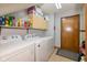 Functional laundry room with washer, dryer, and storage cabinets for supplies at 8111 Timberwood Dr, Plainfield, IN 46168