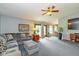 Cozy living room with plush gray carpeting, comfortable seating, and sliding glass doors to the outdoors at 8111 Timberwood Dr, Plainfield, IN 46168