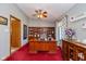 Inviting home office with wood built-ins, a ceiling fan, and a bright window at 8111 Timberwood Dr, Plainfield, IN 46168