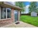 The exterior features a door to the backyard, with a shed and mature trees at 815 Stewart Rd, Anderson, IN 46012