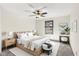 Primary bedroom features a ceiling fan, bedside tables, and a large window for natural light at 815 Stewart Rd, Anderson, IN 46012