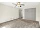 This bedroom features plush carpeting, a ceiling fan, and a spacious closet at 815 Stewart Rd, Anderson, IN 46012