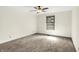 Empty carpeted bedroom with a ceiling fan and a large window at 815 Stewart Rd, Anderson, IN 46012