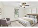 Light filled bedroom featuring stylish decor, a ceiling fan, and large windows at 815 Stewart Rd, Anderson, IN 46012