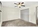 Carpeted bedroom with a ceiling fan and a double-door closet at 815 Stewart Rd, Anderson, IN 46012