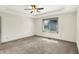 Bright bedroom with neutral carpet, ceiling fan, and a view from the window at 815 Stewart Rd, Anderson, IN 46012