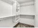 Walk-in closet with custom white shelving and a neutral-toned carpet at 815 Stewart Rd, Anderson, IN 46012