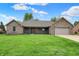 Charming one-story brick home featuring a well-maintained lawn and a covered front porch at 815 Stewart Rd, Anderson, IN 46012