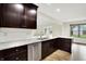 A kitchen featuring stainless steel appliances, granite countertops, and dark wood cabinetry at 815 Stewart Rd, Anderson, IN 46012