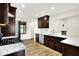 Well-equipped kitchen featuring dark wood cabinetry and granite countertops at 815 Stewart Rd, Anderson, IN 46012