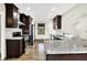 Kitchen featuring stainless steel appliances, granite countertops, and dark wood cabinetry at 815 Stewart Rd, Anderson, IN 46012