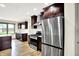 A kitchen with stainless steel appliances and dark wood cabinets offers a modern look at 815 Stewart Rd, Anderson, IN 46012
