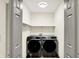 This functional laundry room includes shelving, modern washer and dryer machines at 815 Stewart Rd, Anderson, IN 46012