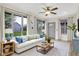 Bright living room with large windows, white sofa, ceiling fan, and neutral decor at 815 Stewart Rd, Anderson, IN 46012