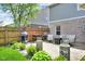 Outdoor patio featuring a grill, fireplace and seating area surrounded by lush landscaping at 8704 New Heritage Dr, Indianapolis, IN 46239