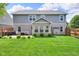 Backyard with patio, green grass, landscaping, and barbecue; perfect for relaxing and entertaining at 8704 New Heritage Dr, Indianapolis, IN 46239