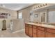 Bright bathroom featuring double vanity, large mirror, and separate tub and shower area at 8704 New Heritage Dr, Indianapolis, IN 46239