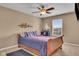 Cozy bedroom featuring a wooden bed frame, neutral walls, and a window with natural light at 8704 New Heritage Dr, Indianapolis, IN 46239