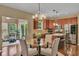 Open dining area featuring a modern chandelier, glass table, and stainless steel appliances at 8704 New Heritage Dr, Indianapolis, IN 46239