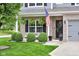 Charming covered front porch with seating area and an American flag, showcasing curb appeal at 8704 New Heritage Dr, Indianapolis, IN 46239