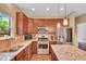 Well-lit kitchen boasts stainless steel appliances, granite countertops, and updated cabinetry at 8704 New Heritage Dr, Indianapolis, IN 46239