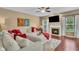 Comfortable living room with a fireplace, large sofa, and hardwood floors at 8704 New Heritage Dr, Indianapolis, IN 46239