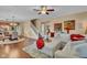 Open-concept living space with a large sofa, hardwood floors, and dining area nearby at 8704 New Heritage Dr, Indianapolis, IN 46239